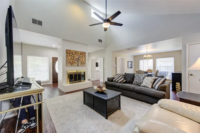 a living room with furniture ceiling fan and a window