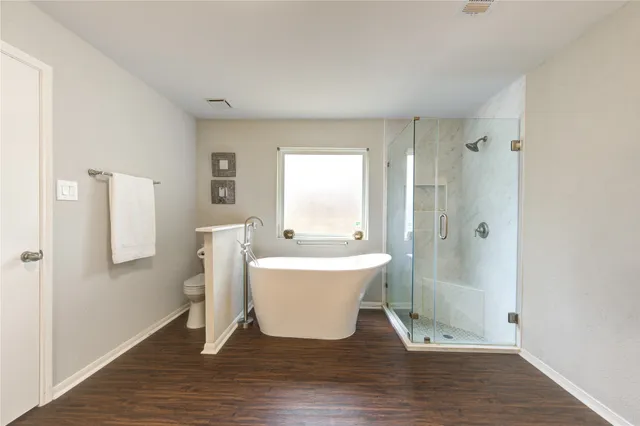 a bathroom with a bathtub and shower