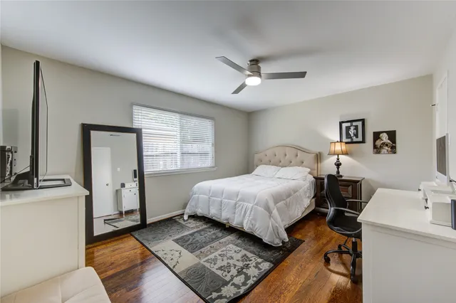 a spacious bedroom with a bed and a chandelier