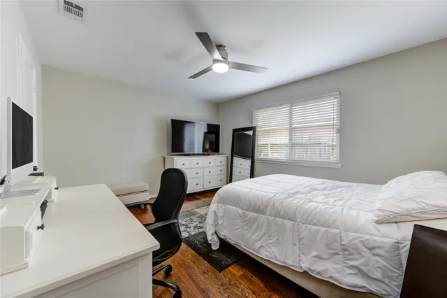 a bedroom with a bed and a large window