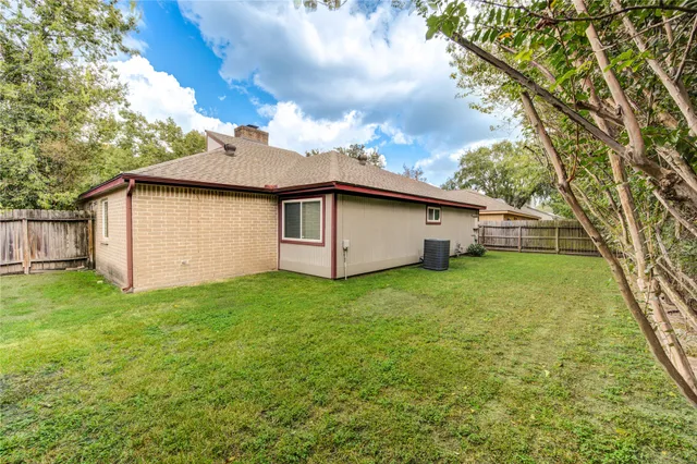 a white house that has a tree in front of it