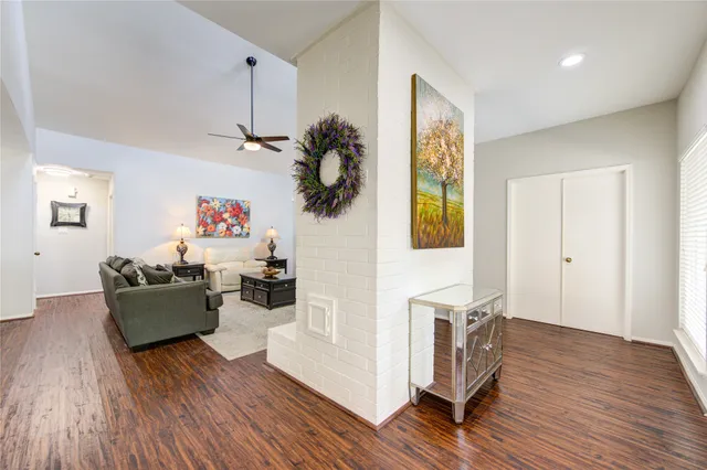 a living room with furniture and a wooden floor