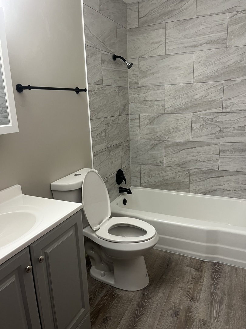 7831 Roberts Road, Unit 3 Bridgeview, IL 60455 - Photo 6 of 7 a bathroom with a toilet a sink and mirror