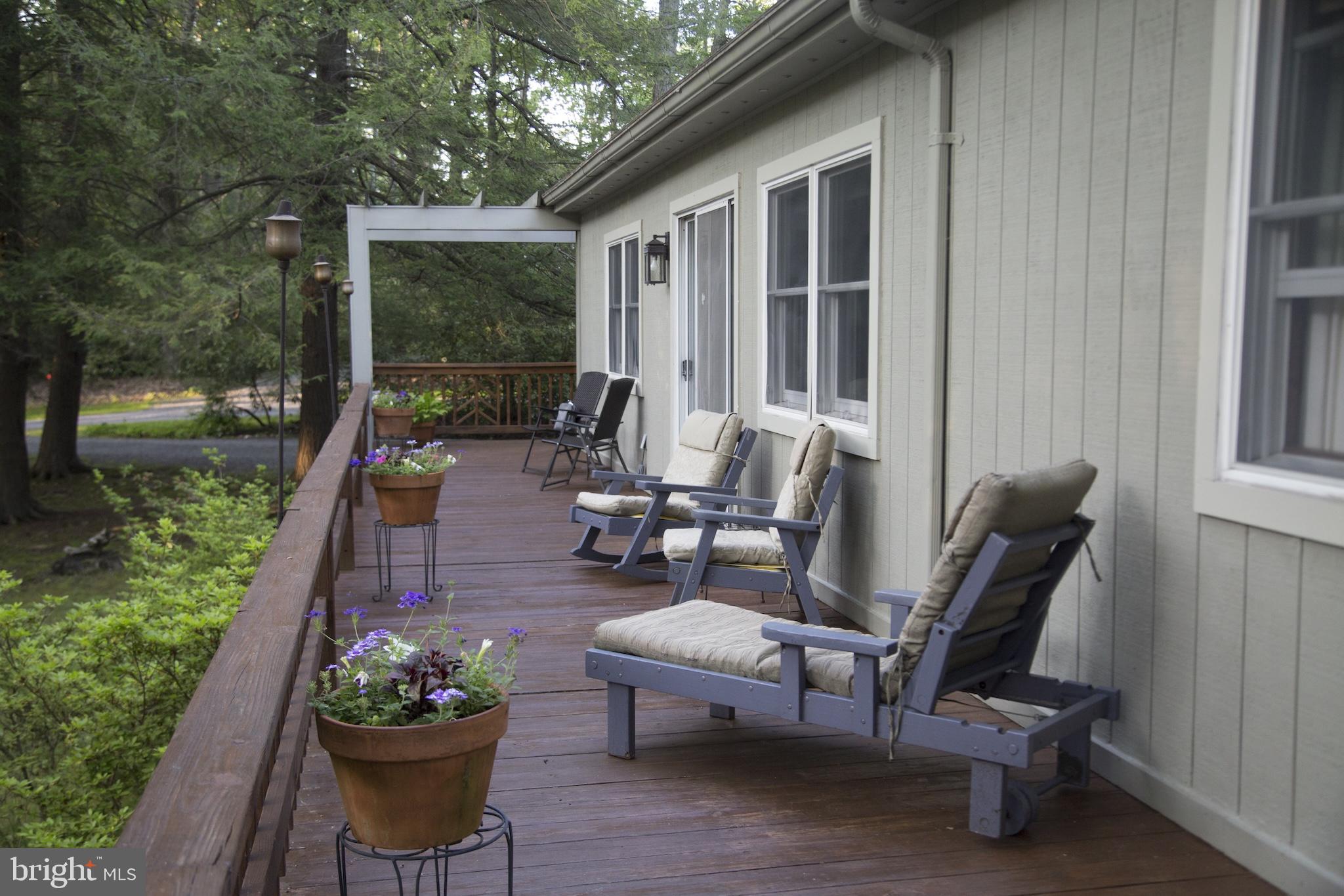 346 Skippers Point Road Oakland, MD 21550 - Photo 46 of 73 a view of a patio with chairs potted plants and a fountain