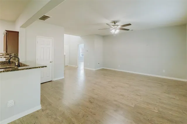 a kitchen with stainless steel appliances granite countertop a stove microwave and sink