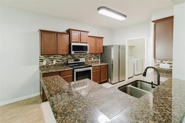 a view of a kitchen with electric appliances