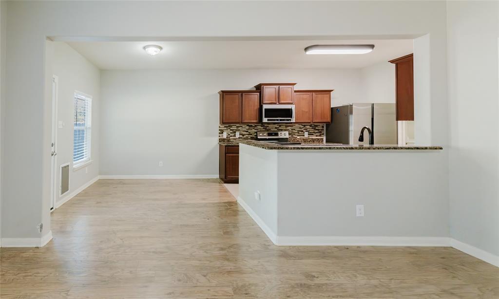 12637 Forest Lawn Road Rhome, TX 76078 - Photo 18 of 31 a view of a kitchen with electric appliances