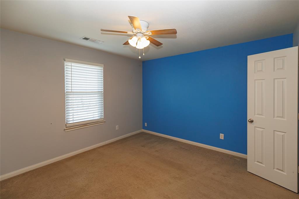 12637 Forest Lawn Road Rhome, TX 76078 - Photo 19 of 31 an empty room with a window and a ceiling fan