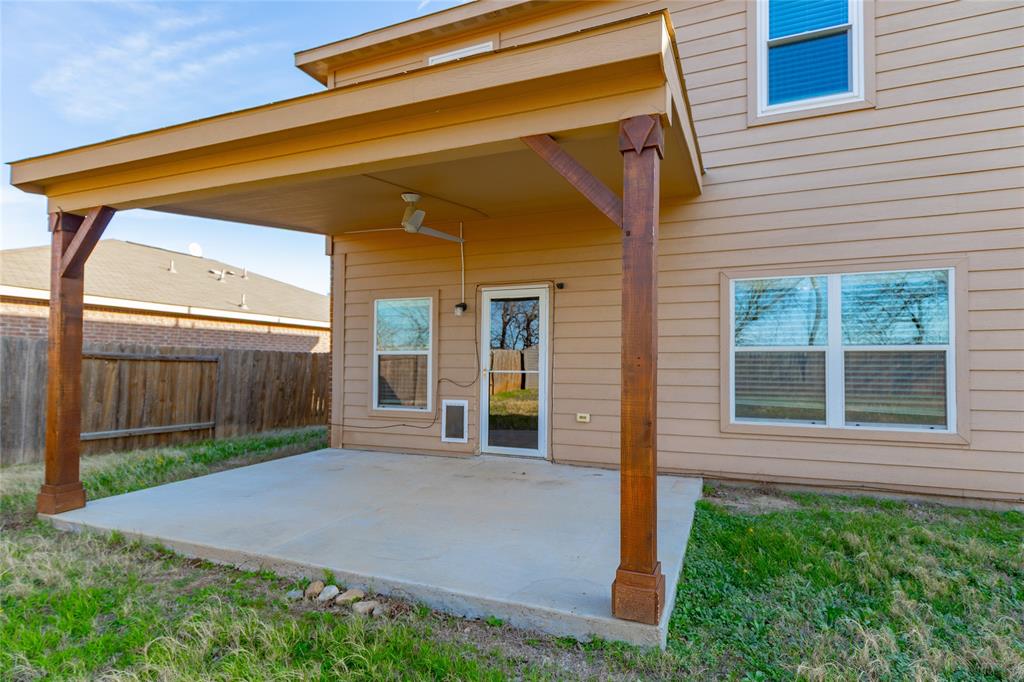 12637 Forest Lawn Road Rhome, TX 76078 - Photo 25 of 31 a view of yellow house with a small yard and wooden fence
