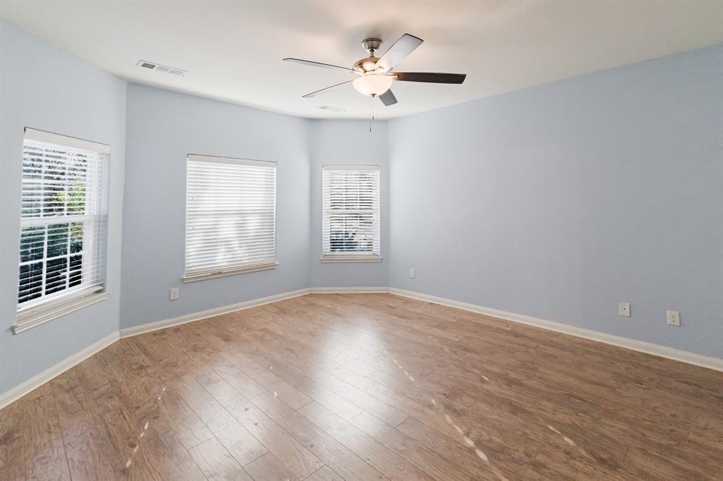 12637 Forest Lawn Road Rhome, TX 76078 - Photo 3 of 31 an empty room with windows and ceiling fan