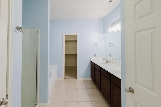 a bathroom with a double vanity sink and mirror