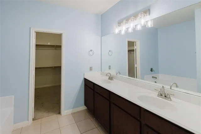 a bathroom with a double vanity sink and a mirror