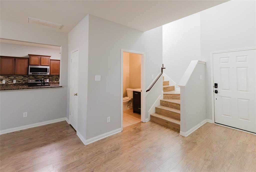 12637 Forest Lawn Road Rhome, TX 76078 - Photo 9 of 31 a view of a livingroom with wooden floor and stairs