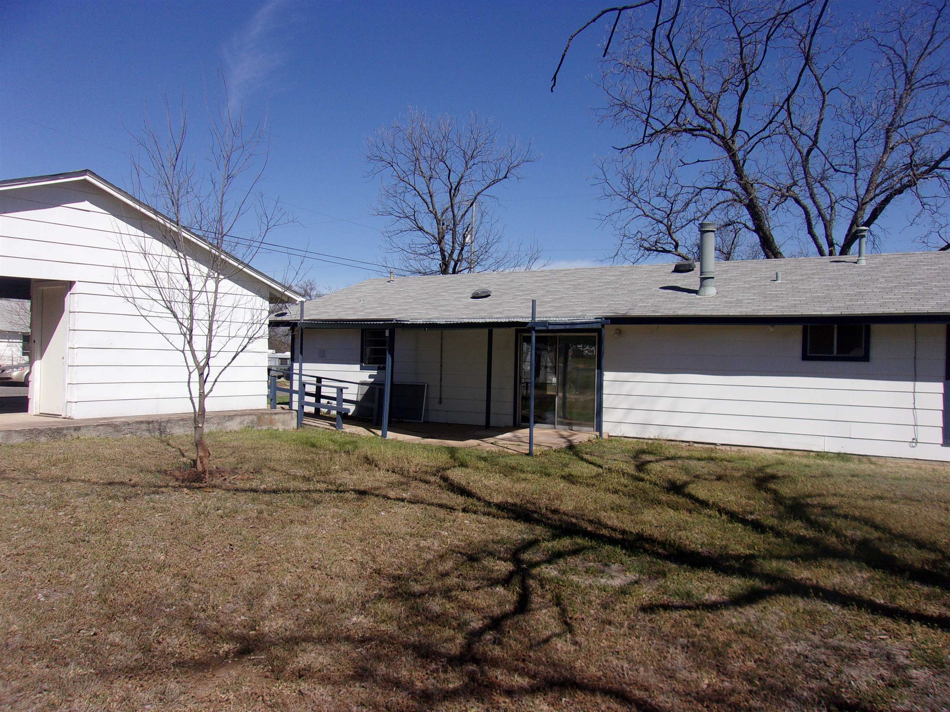 900 East Wallace Street Llano, TX 78643 - Photo 13 of 16 a house with trees in the background