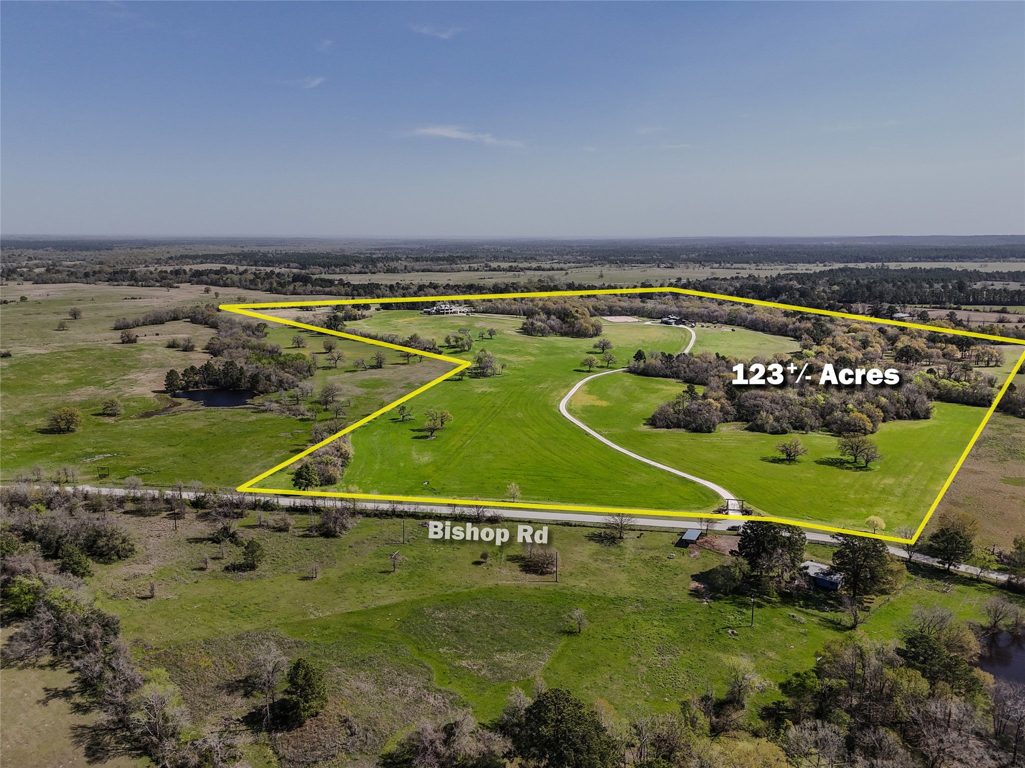 460 Bishop Road Huntsville, TX 77320 - Photo 2 of 50 A broad aerial of the entire property, giving a sense of its size, layout, and surroundings. The home sits atop a hill at one of the highest elevations in Walker County, offering breathtaking panoramic views that stretch for miles.