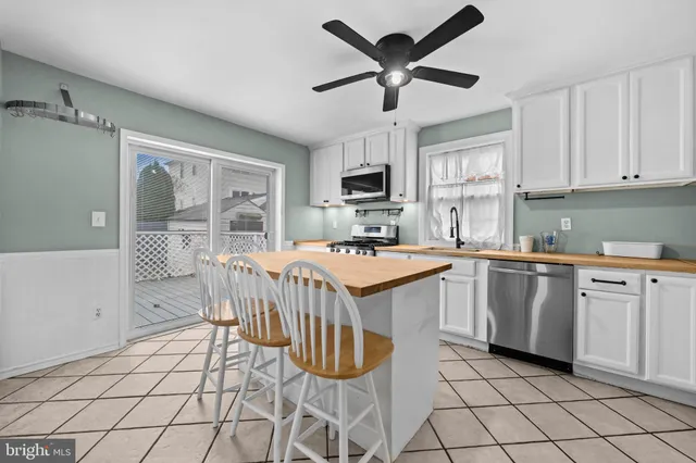 a kitchen with a stove a sink and a refrigerator