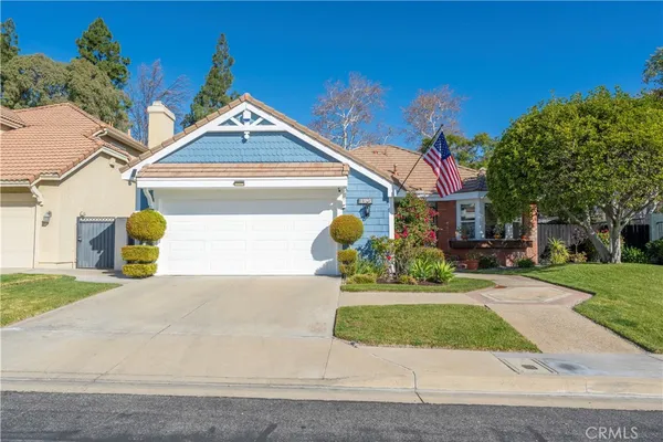 a front view of a house with a yard and a garage