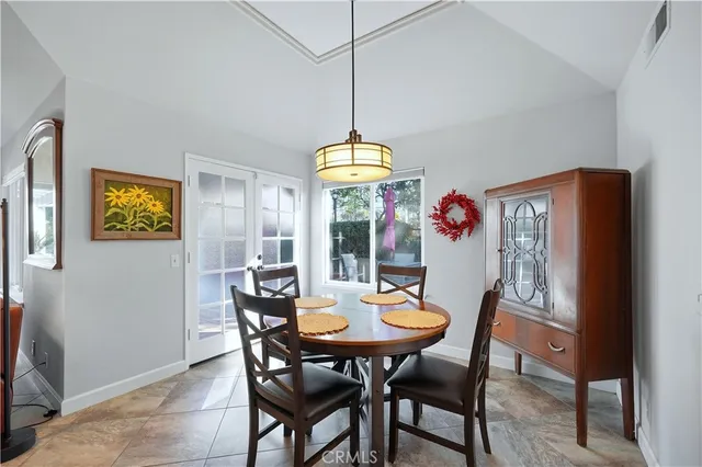 a dining room with furniture a chandelier and window