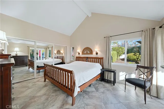 a bed room with a bed and a chair