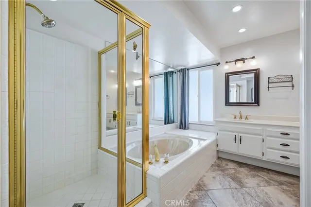 a bathroom with a tub sink and mirror