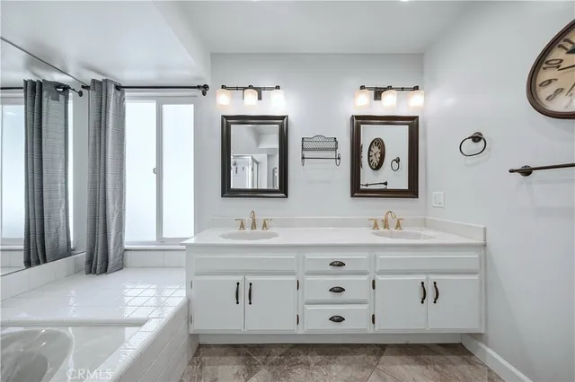 a bathroom with a double vanity sink mirror and