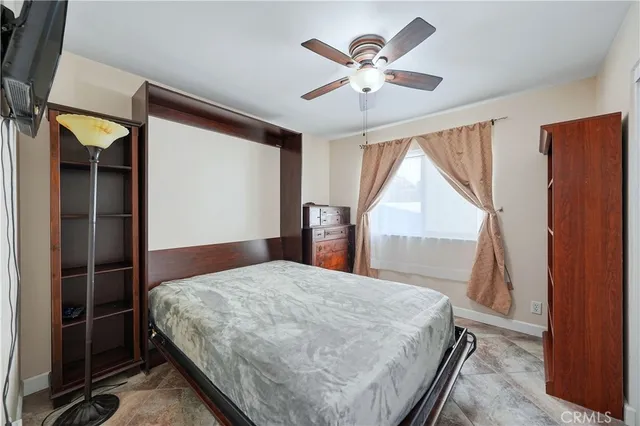 a bedroom with a large bed and a chandelier
