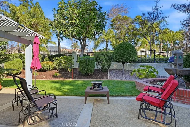 a view of a chairs and table in backyard of the house
