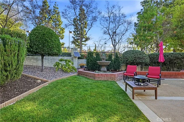 a view of a backyard with sitting area and wooden fence