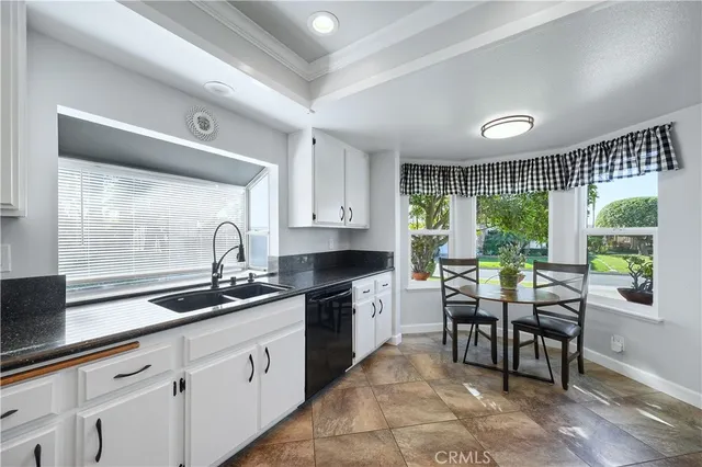 a kitchen with sink cabinets and outdoor view
