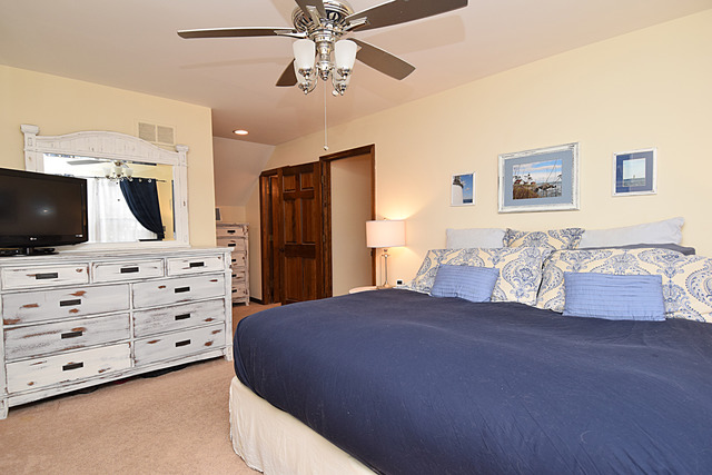 N040 Pierce Avenue Wheaton, IL 60187 - Photo 12 of 20 a bedroom with a large bed and a flat screen tv