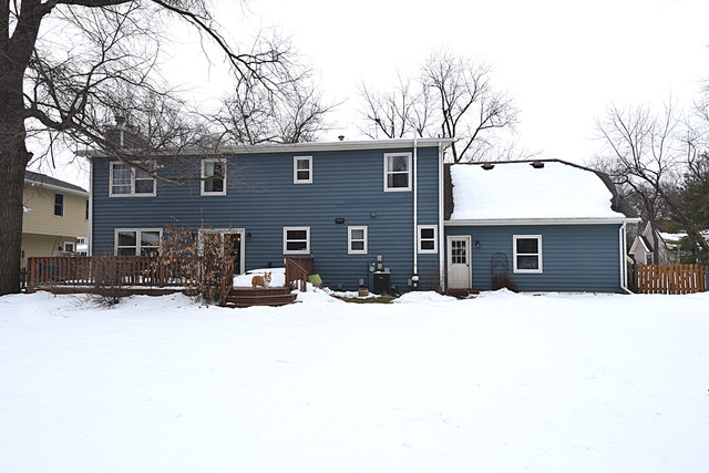 N040 Pierce Avenue Wheaton, IL 60187 - Photo 18 of 20 a front view of a house with a yard covered in snow