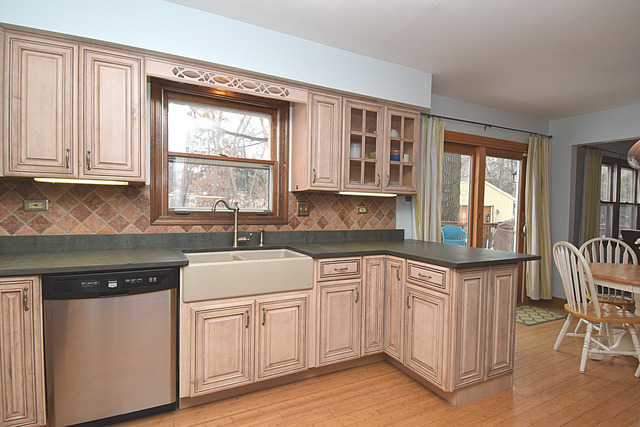 N040 Pierce Avenue Wheaton, IL 60187 - Photo 7 of 20 a kitchen with granite countertop white cabinets and wooden floor