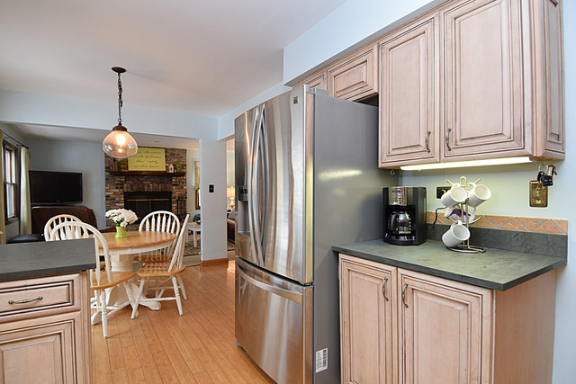 N040 Pierce Avenue Wheaton, IL 60187 - Photo 8 of 20 a kitchen with granite countertop a refrigerator a stove a sink dishwasher a dining table and chairs with wooden floor