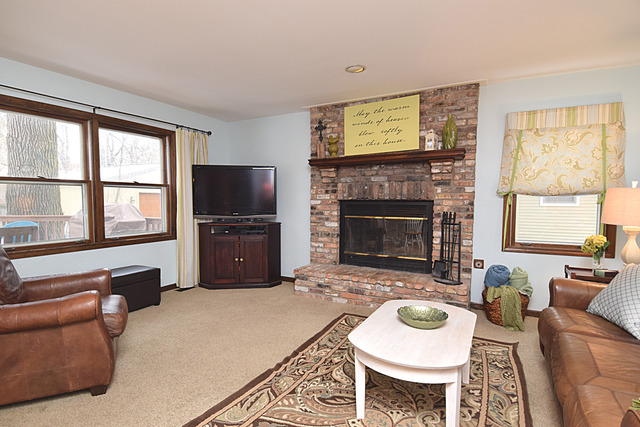 N040 Pierce Avenue Wheaton, IL 60187 - Photo 9 of 20 a living room with furniture a window and a fireplace