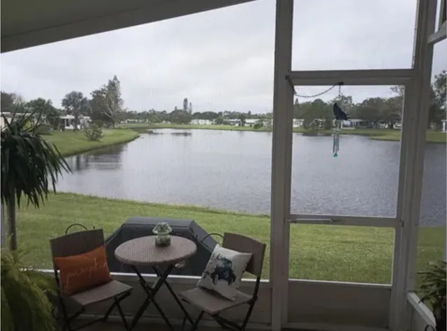 a balcony with furniture and a lake view