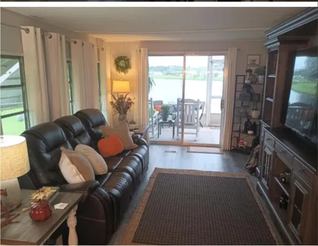 a bedroom with a bed table and window