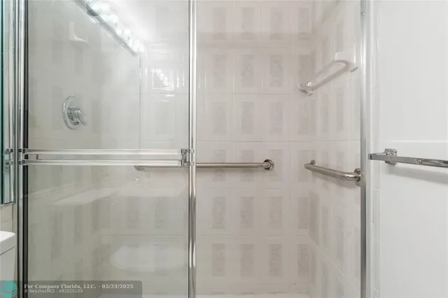 a bathroom with a glass shower door
