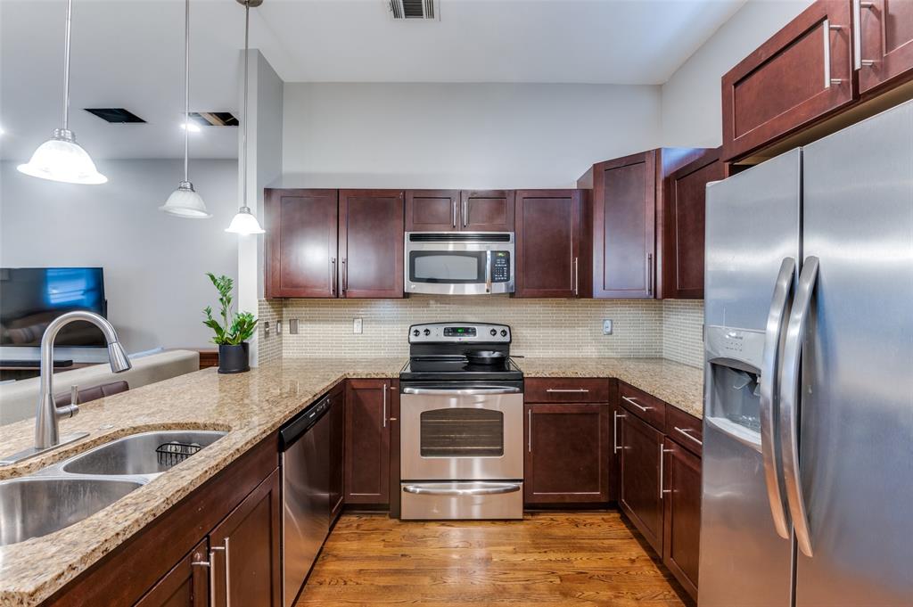 5618 Lindell Avenue, Unit 7 Dallas, TX 75206 - Photo 18 of 18 a kitchen with stainless steel appliances granite countertop a sink a stove and a refrigerator