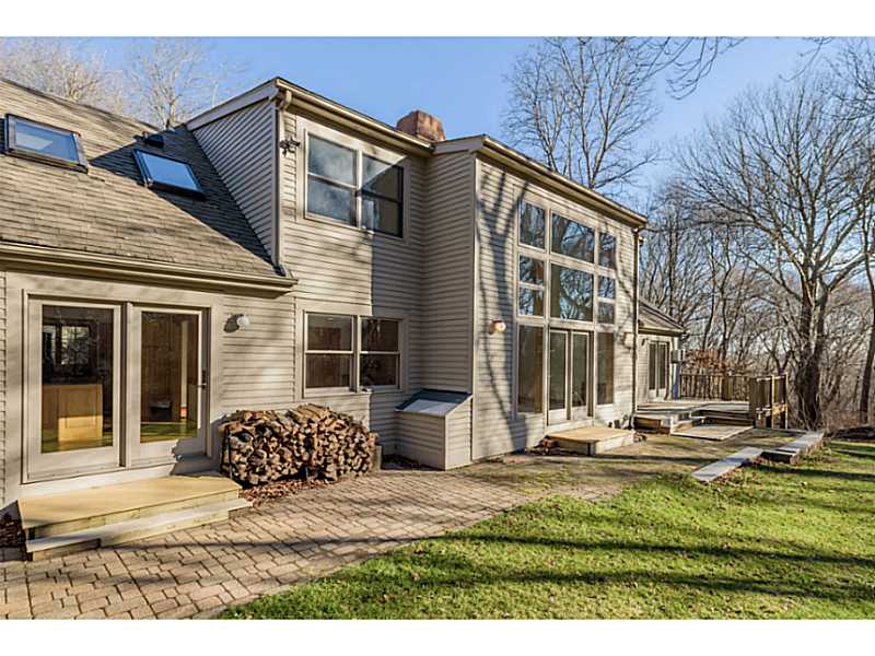 746 Middlebridge Road South Kingstown, RI 02879 - Photo 4 of 25 Exterior Back. Stacked woodpile with access to house.