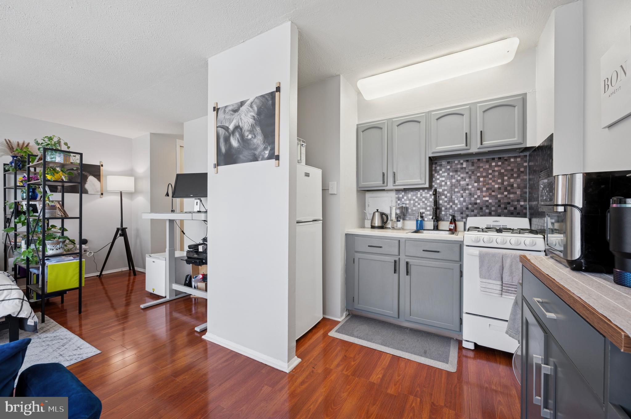 2101 Chestnut Street, Unit 1107 Philadelphia, PA 19103 - Photo 6 of 19 a kitchen with a refrigerator and a stove top oven