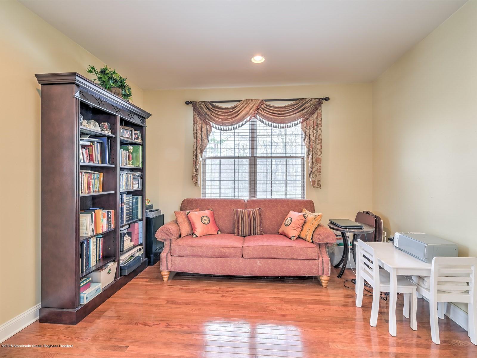 20 Emily Road Manalapan, NJ 07726 - Photo 14 of 25 a living room with furniture a window and a book shelf
