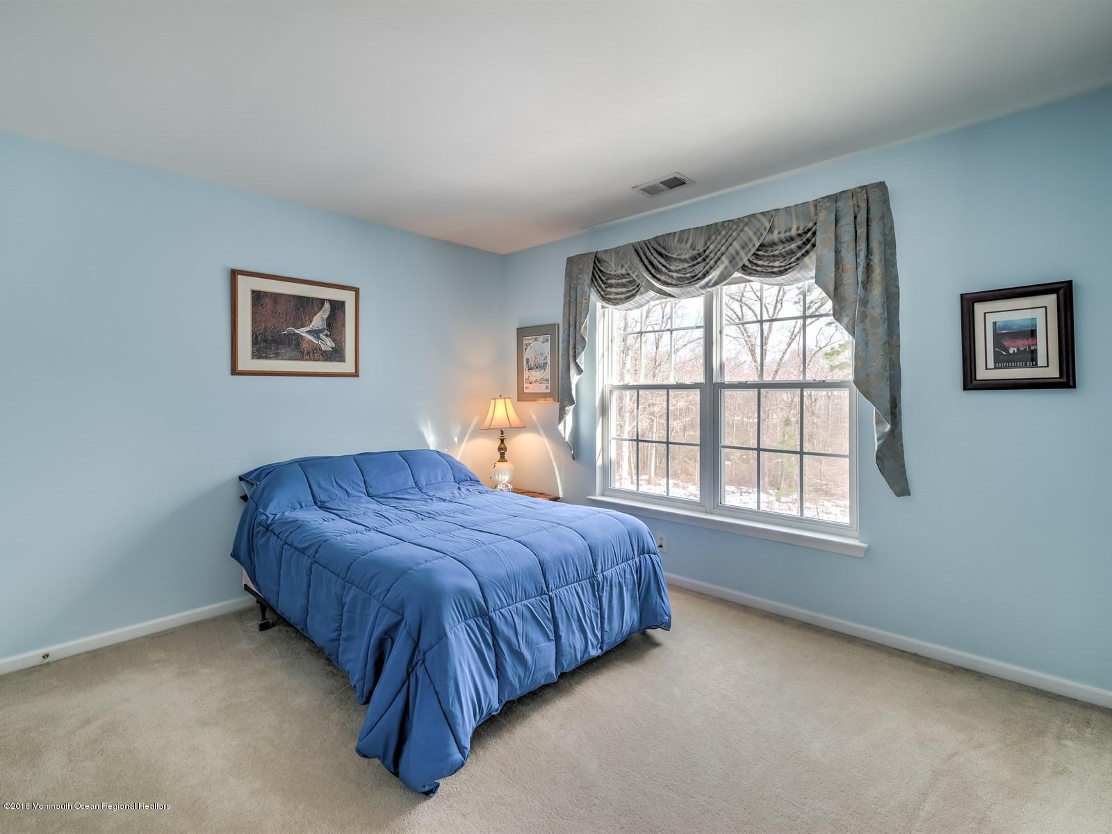 20 Emily Road Manalapan, NJ 07726 - Photo 22 of 25 a spacious bedroom with a bed and a window