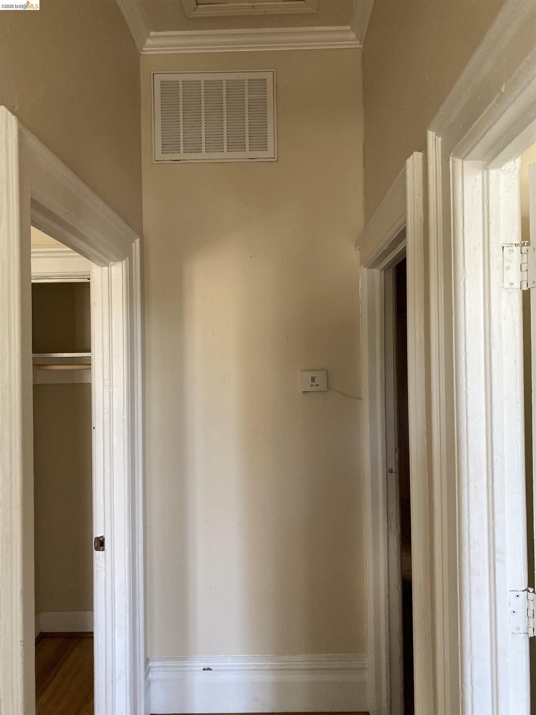 1133 Wood Street Oakland, CA 94607 - Photo 8 of 25 Hallway featuring crown molding and baseboards, light-toned walls, and multiple doorways with trim