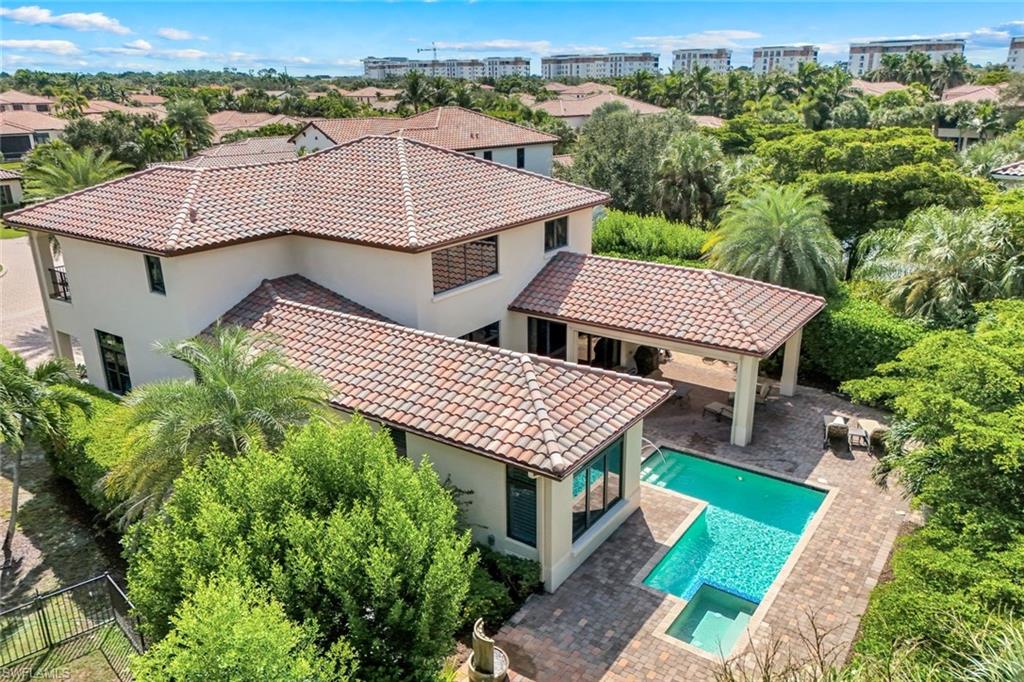 2351 Traditions Court Naples, FL 34105 - Photo 1 of 48 an aerial view of a house with a garden