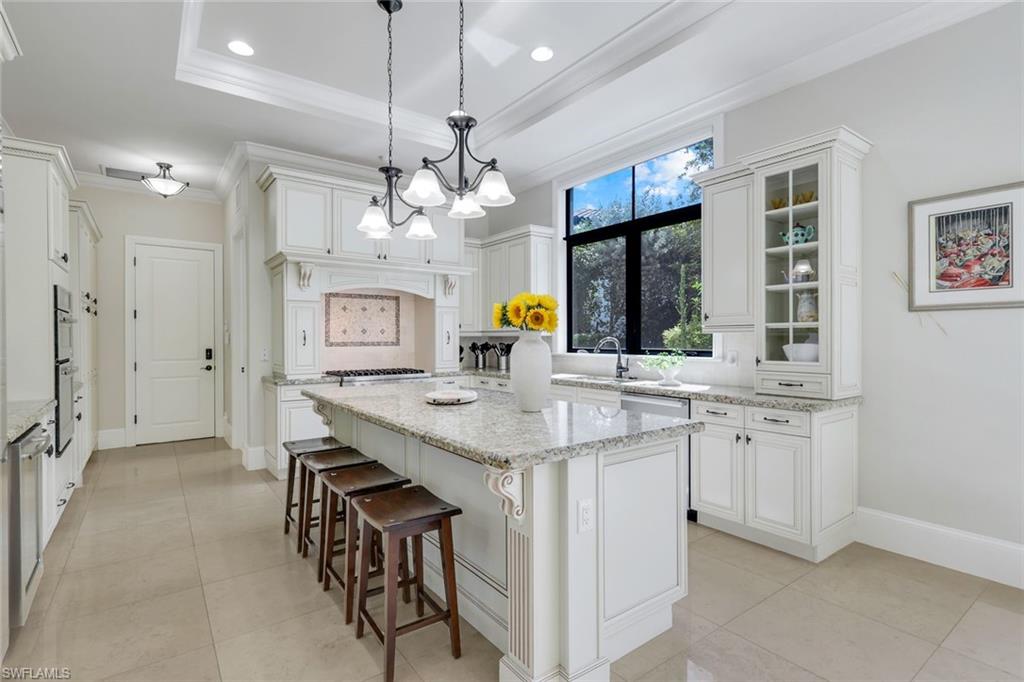 2351 Traditions Court Naples, FL 34105 - Photo 14 of 48 a view of a kitchen island a chandelier furniture and a chandelier