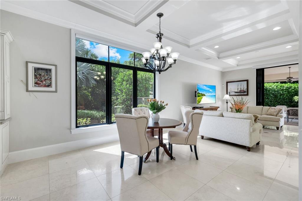 2351 Traditions Court Naples, FL 34105 - Photo 18 of 48 a dining room with furniture a chandelier and window