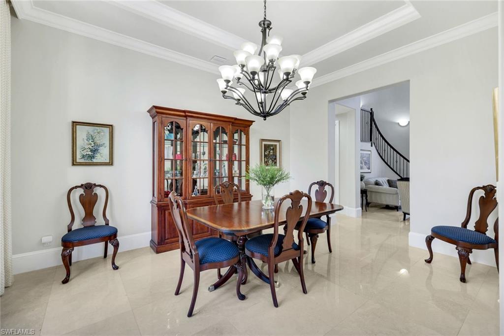 2351 Traditions Court Naples, FL 34105 - Photo 19 of 48 a dining room with furniture and chandelier
