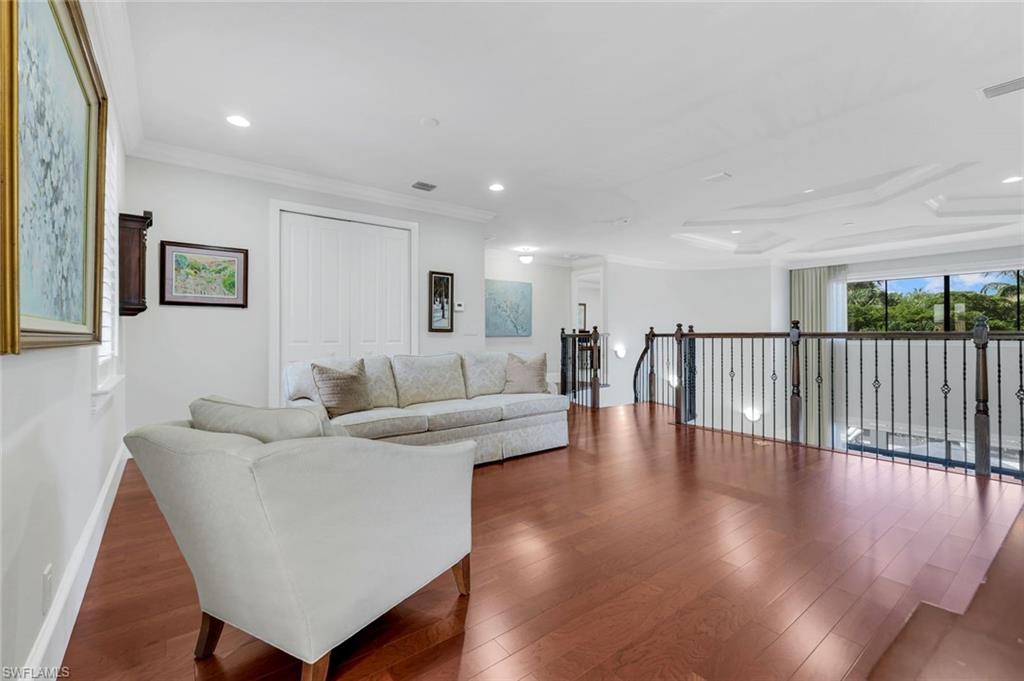 2351 Traditions Court Naples, FL 34105 - Photo 21 of 48 a living room with furniture and a wooden floor