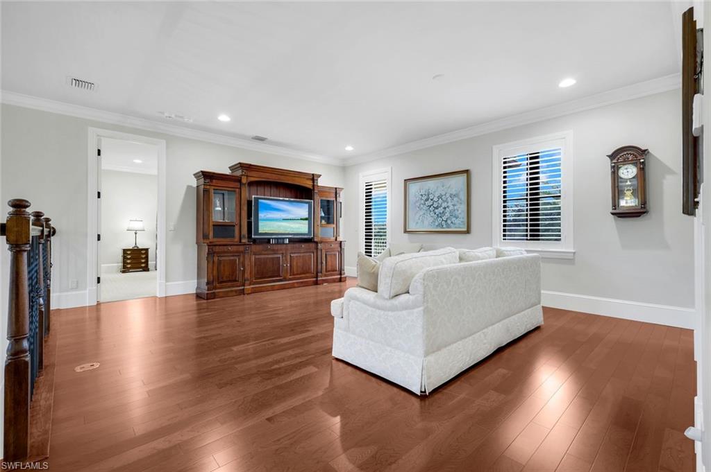 2351 Traditions Court Naples, FL 34105 - Photo 22 of 48 a living room with furniture and a flat screen tv