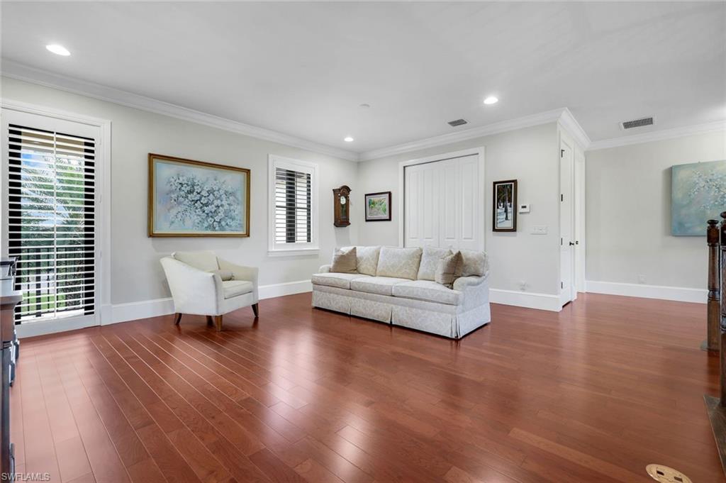 2351 Traditions Court Naples, FL 34105 - Photo 23 of 48 a living room with furniture and a wooden floor